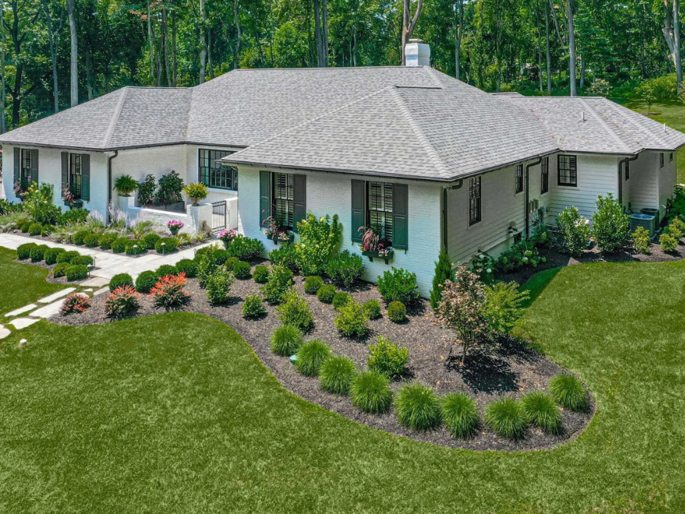 Beautifully landscaped side-front yard in Wilmington, DE featuring mulch, shrubbery, and green grass