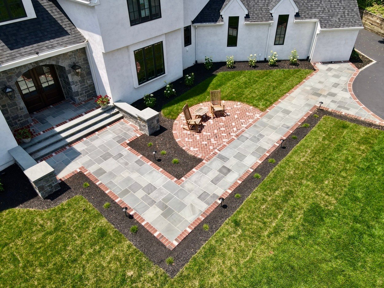 Aerial view of symmetrical hardscape and curved brick patio in custom hardscaping and landscaping in Wilmington, DE