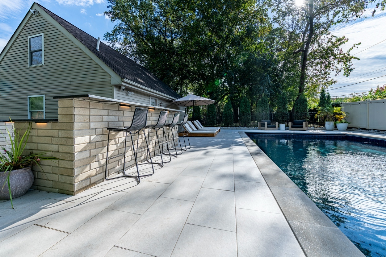 Built-in outdoor kitchen with stainless steel appliances and custom hardscaping in Wilmington, DE.