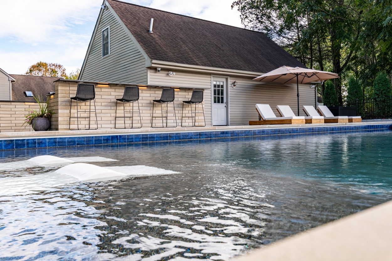 Pool waterline detail with adjacent patio featuring custom hardscaping in Wilmington, DE