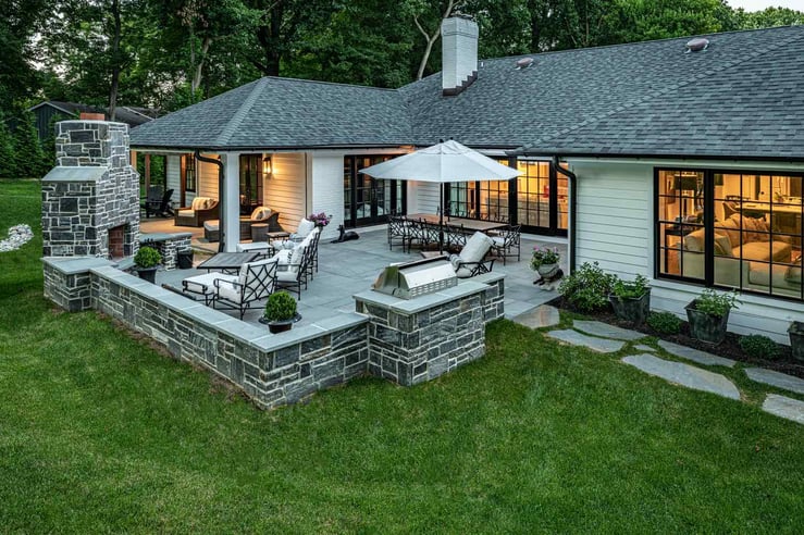 Hardscaped Back Yard With Fireplace and Seating By First Class Lawncare, LLC.