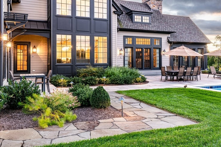 Custom back patio featuring landscape lighting and pool deck in Wilmington, DE