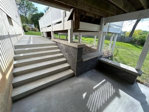 Under deck concrete stairs and landing by First Class Lawncare