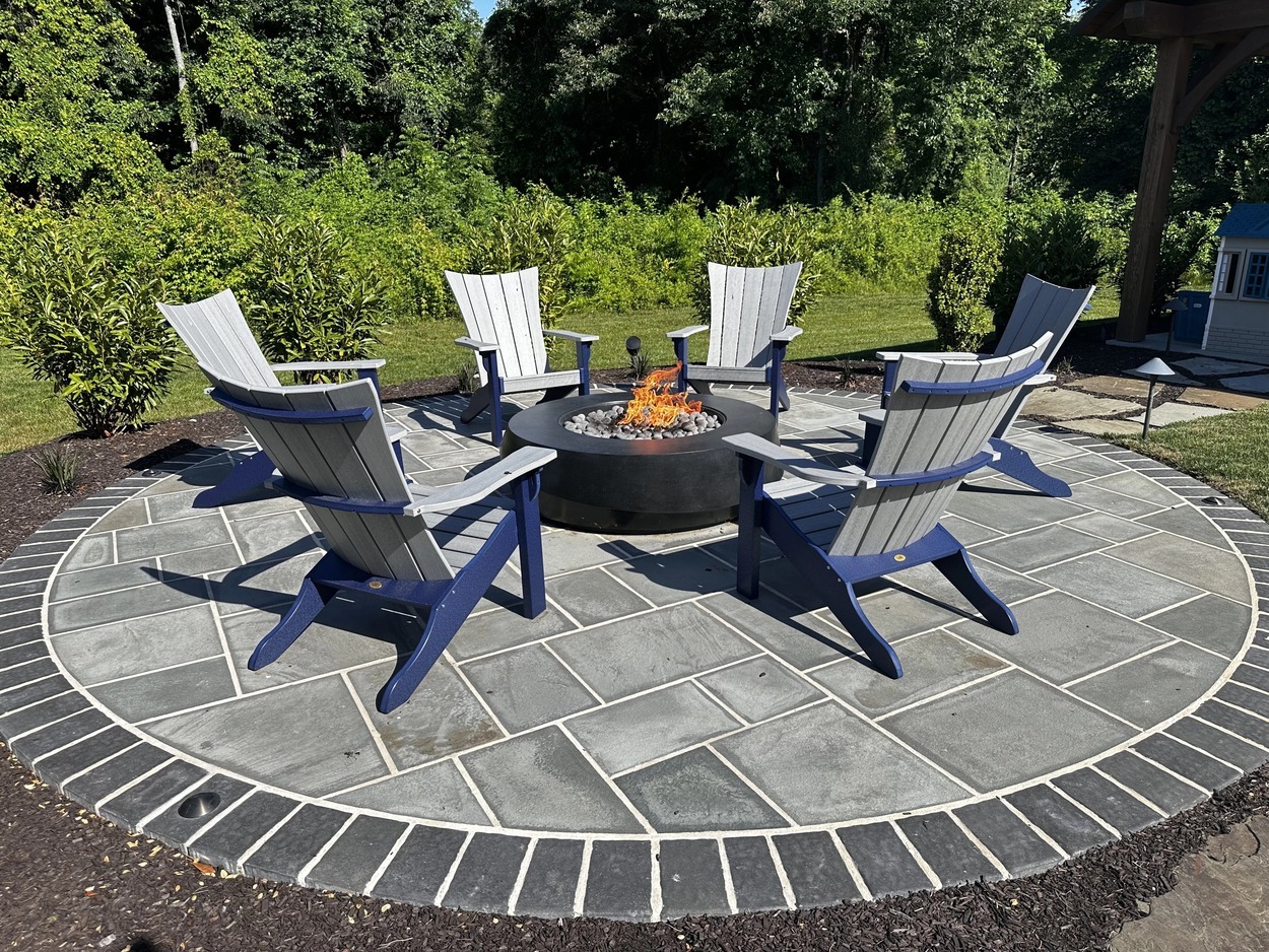 Side view of patio firepit sitting area by First Class Lawncare, LLC. in Wilmington, DE