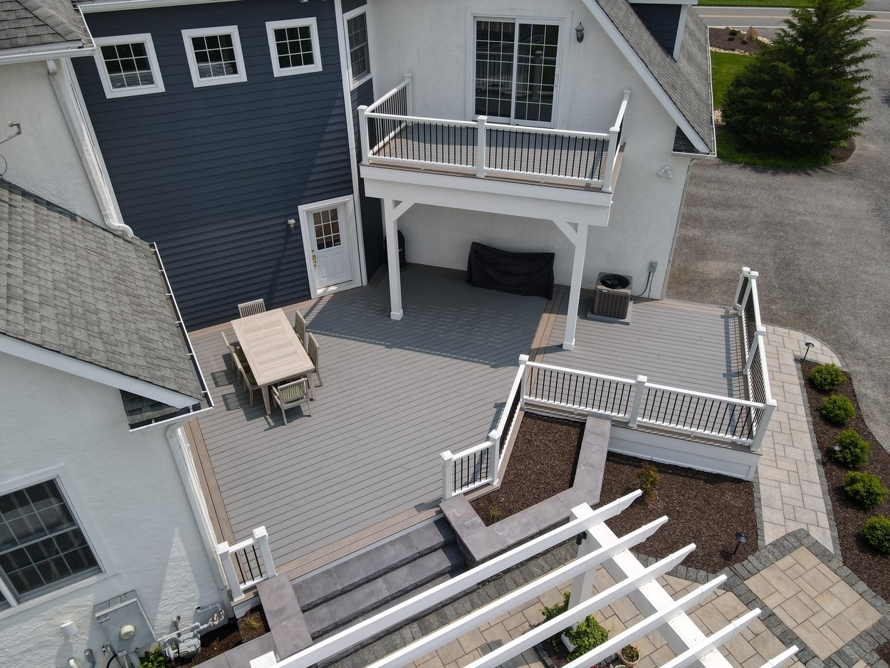 Deck with outdoor dining table and balcony in an outdoor living project in Newark, DE