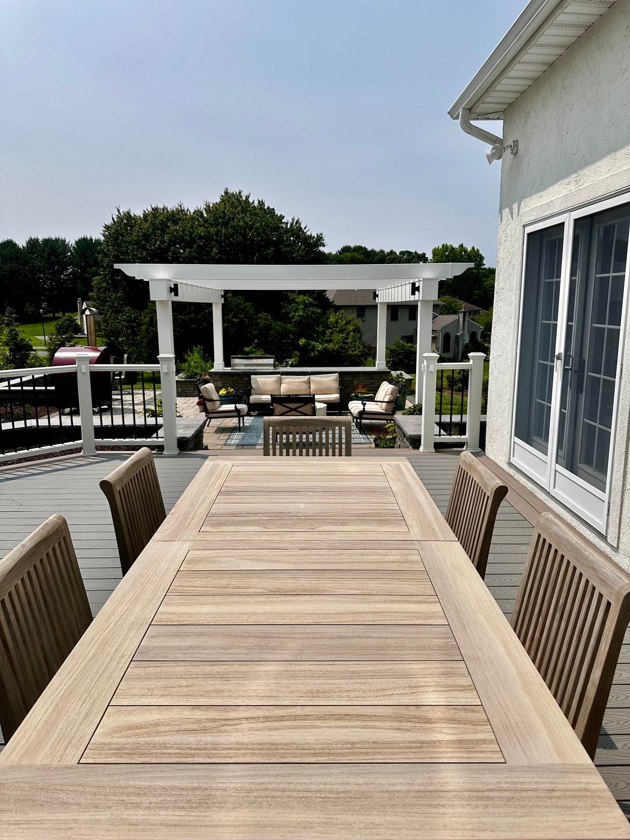 Dining table on raised deck with view of outdoor living space in Newark, DE