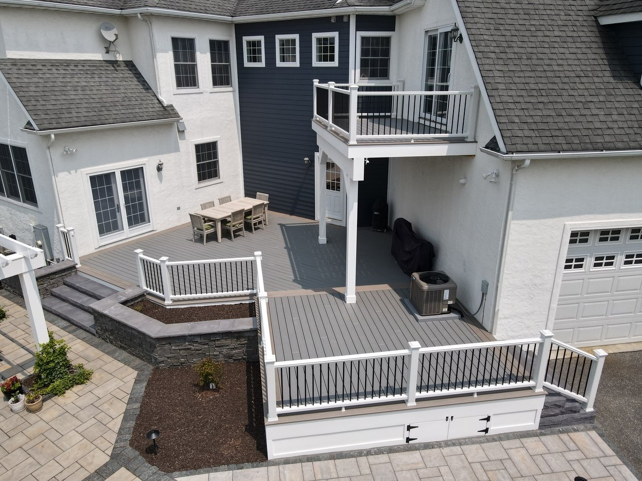 Elevated deck installation with patio access as part of an outdoor living project in Newark, DE