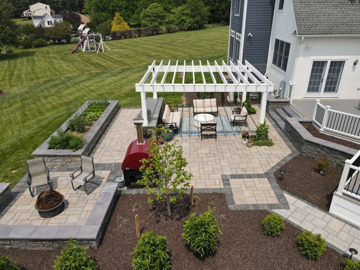 Pergola-covered seating and garden beds in an outdoor living project in Newark, DE