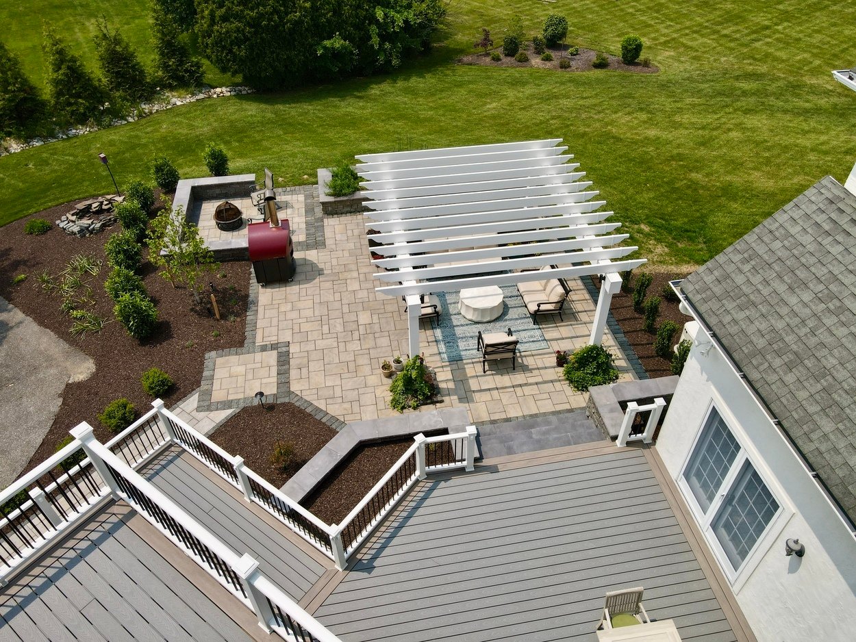 Top-down view of deck and paver patio with pergola and pizza oven in an outdoor living project in Newark, DE