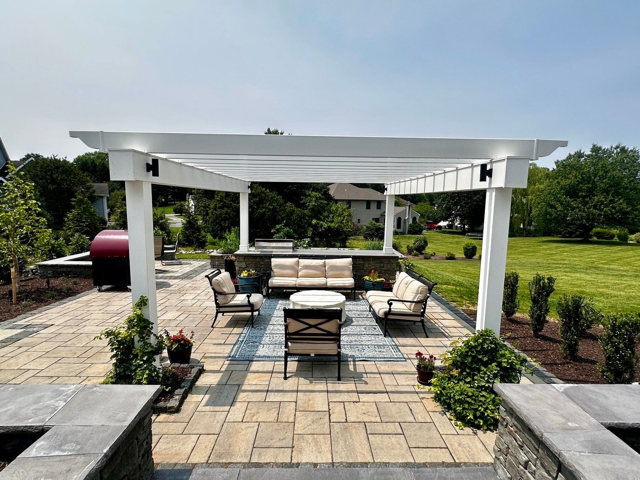 White pergola over paver patio and outdoor furniture for an outdoor living project in Newark, DE