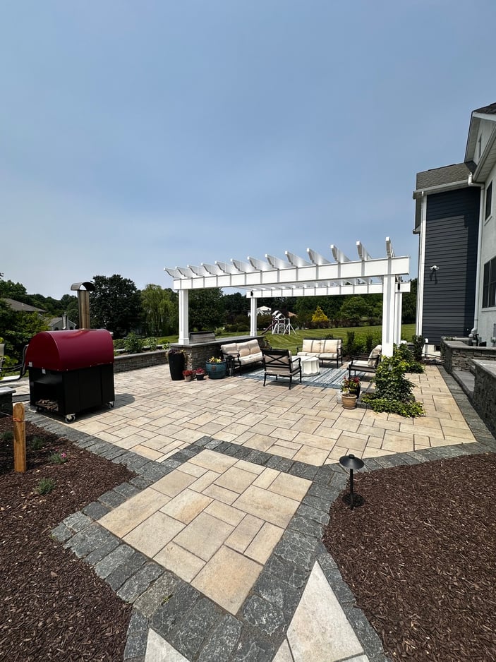 Wide paver walkway leading to pergola lounge area in outdoor living project in Newark, DE