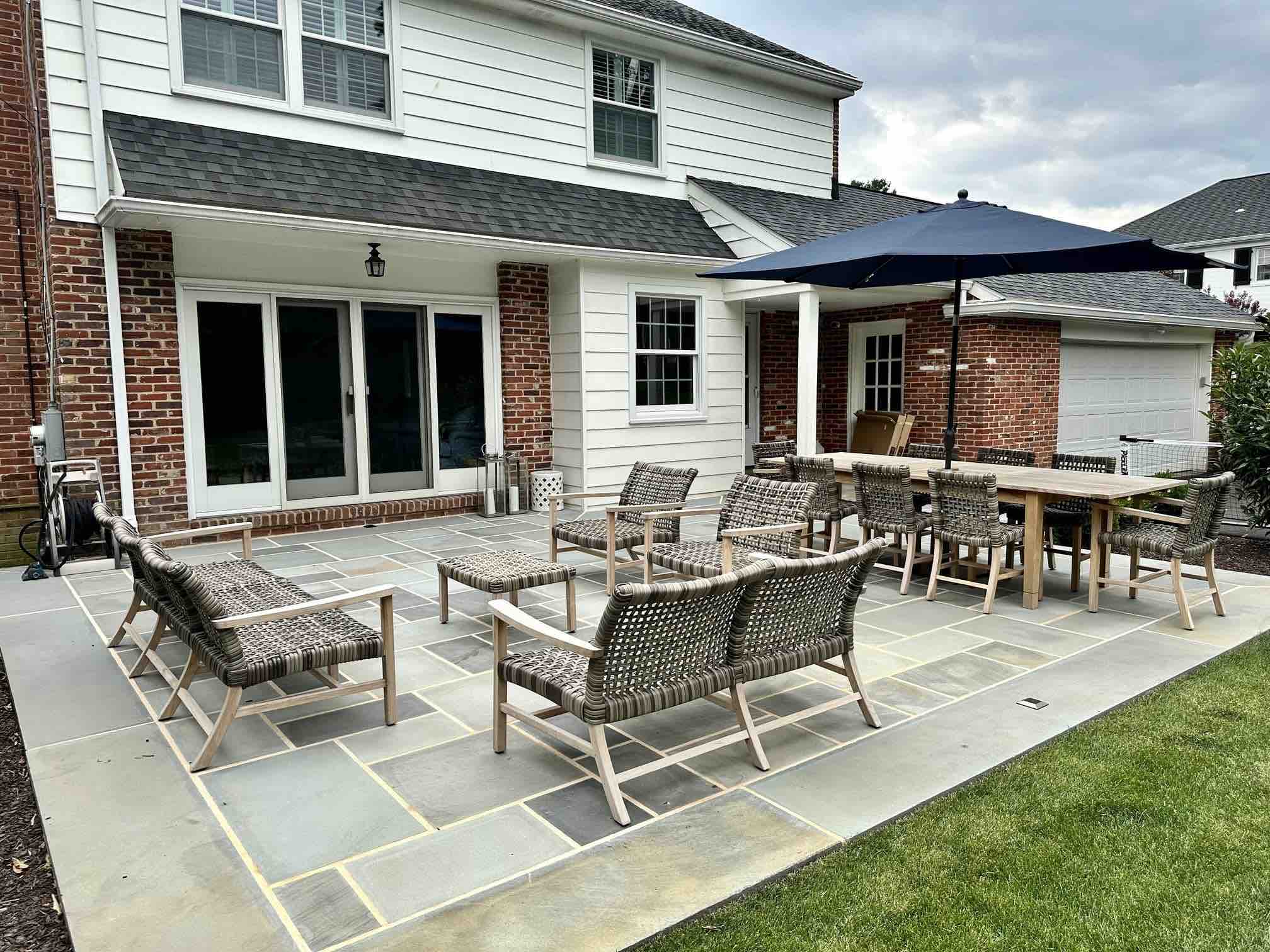 Patio With Seating in Back Yard by First Class Lawn Care
