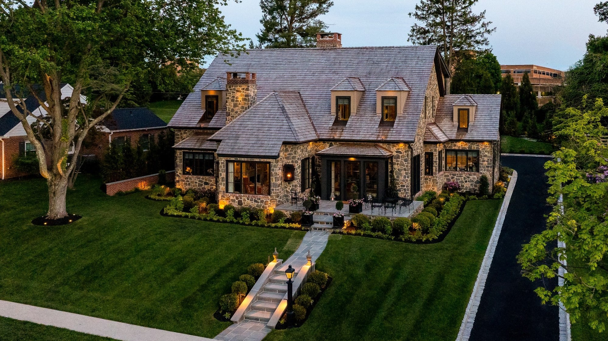 wilmington de exterior project aerial view of stone home with landscaped front yard at twilight